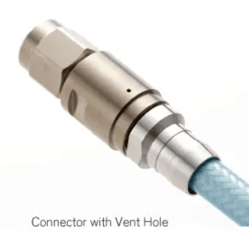 Vented RF connector showing the small vent hole that allows trapped gas to escape during vacuum pump-down